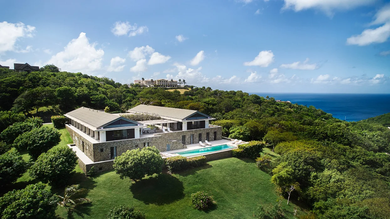 Aerial view of Marguerite in the Endeavour Hills on Mustique, with the infinity pool and wraparound sea